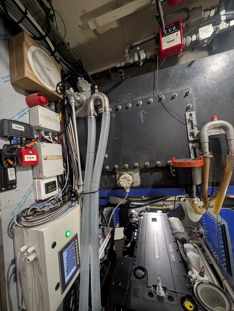 Ship engine room with a Volvo Penta D6-300 and bulkhead-mounted control panels